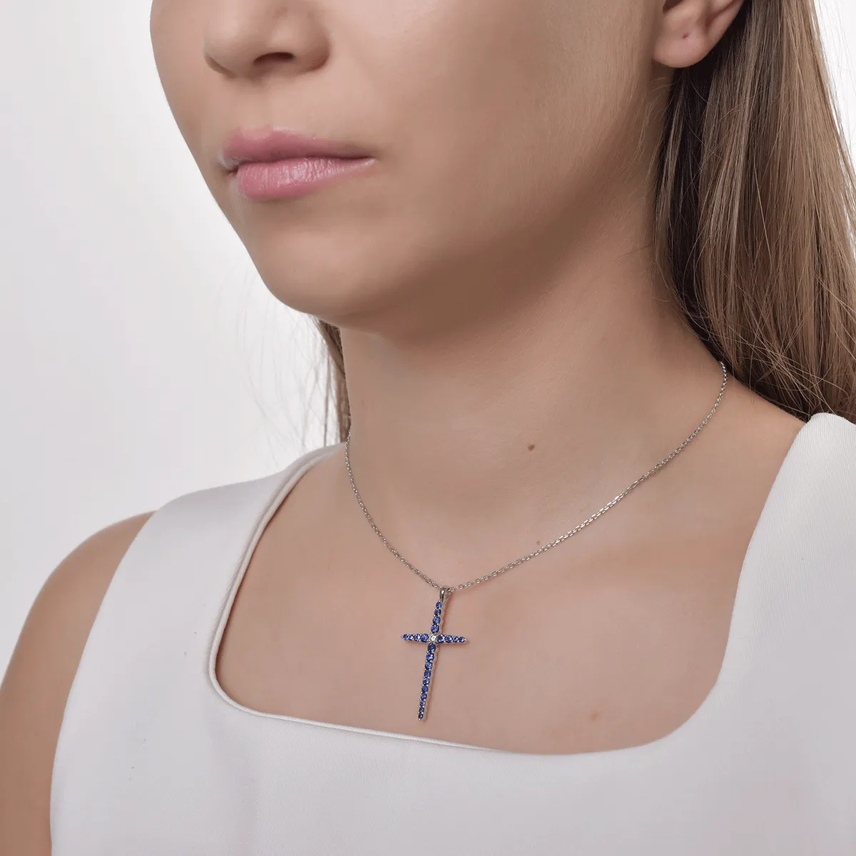 18K white gold cross pendant necklace with 1.1ct sapphires and a 0.09ct diamond