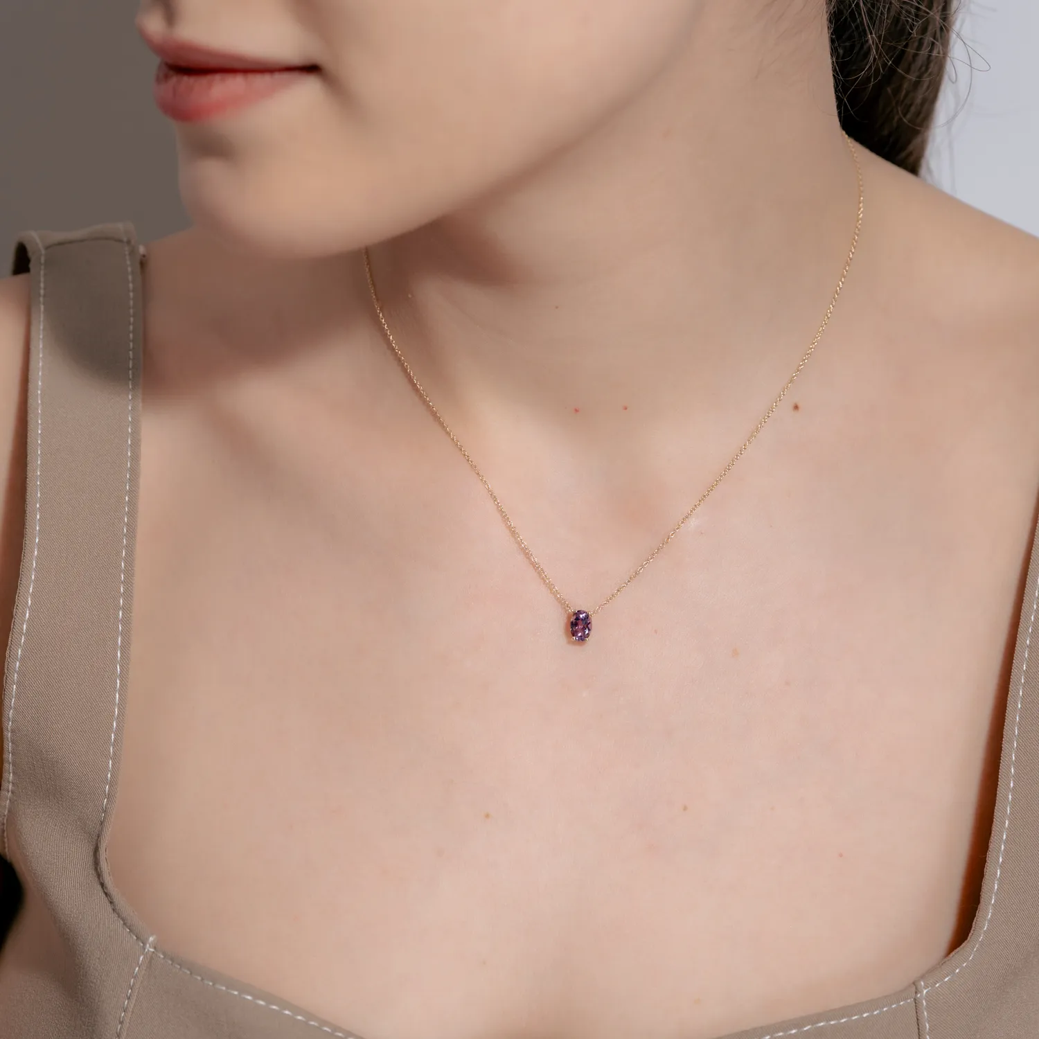 Yellow gold minimalist pendant necklace with purple solitaire zirconia