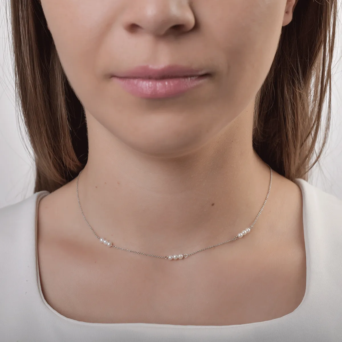 White gold necklace with synthetic pearls