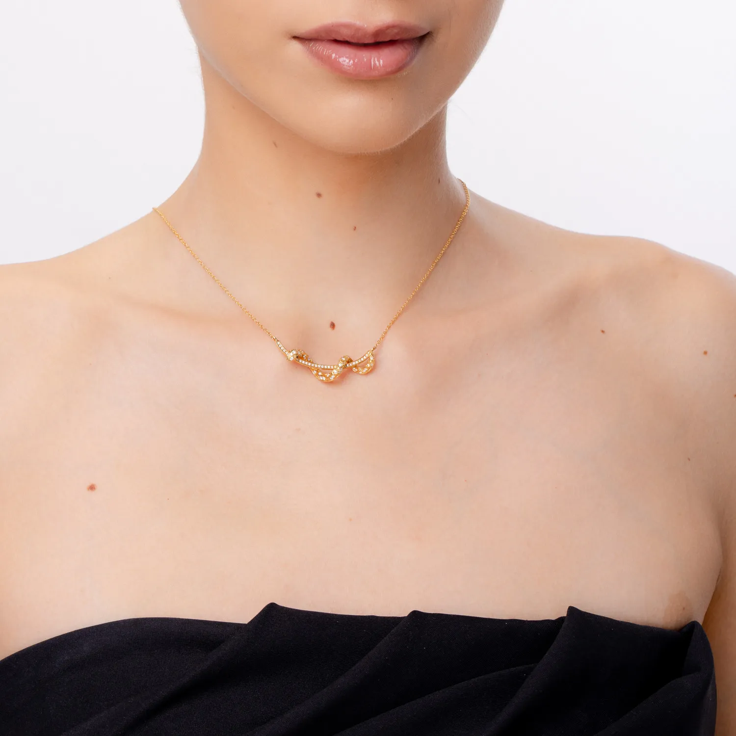 Yellow gold snake pendant necklace with 0.5ct clear and black diamonds