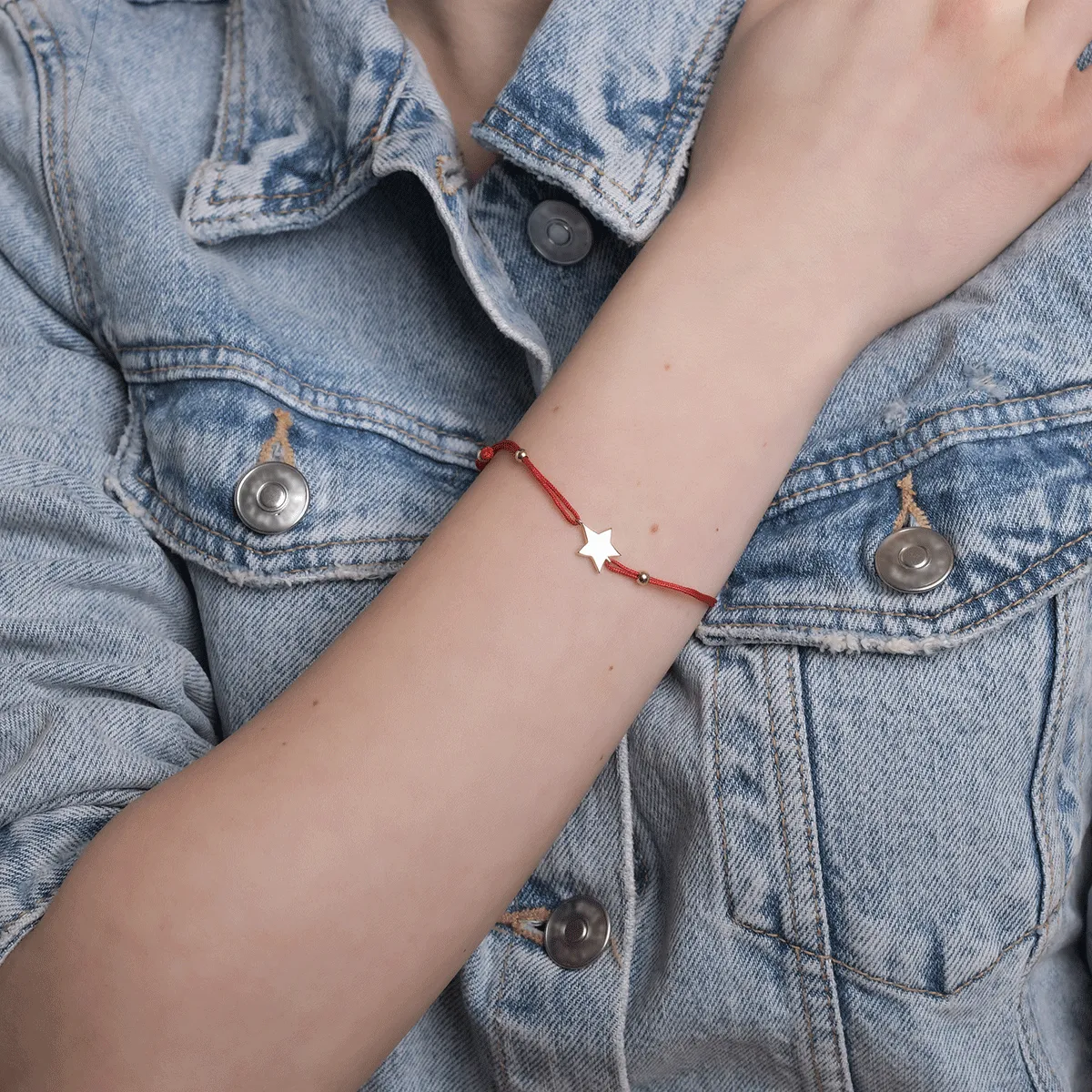 Red cord bracelet with 14K yellow gold star charm